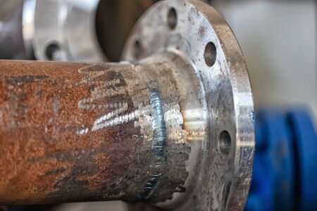 Weld the flange weld to the pipe. Welding - manual arcの写真素材