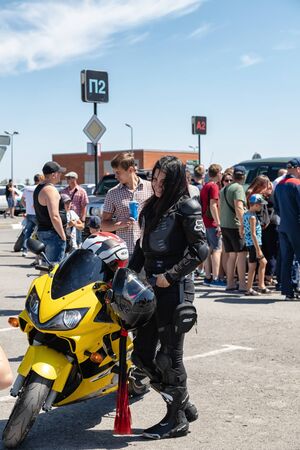 VOLGOGRAD, RUSSIA - JULY 7: Biker girl with her yellow sports motorcycle at motorcycle show. July 7, 2019 in Volgograd, Russia.のeditorial素材
