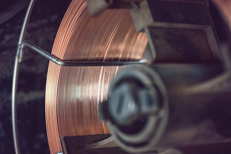 Working atmosphere in an old welding shop with a focus on the coil of welding wire for automatic welding in shielding gasesの写真素材