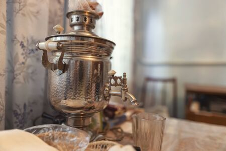 In village house kitchen on the table is an old samovar and faceted glassの写真素材
