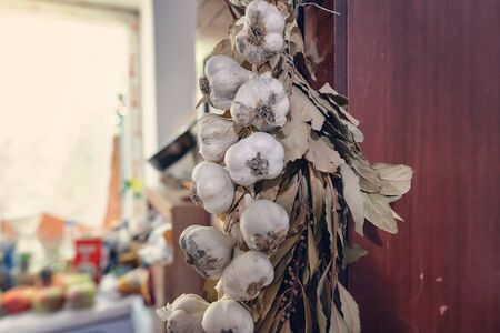 In the kitchen in the village house there is always a bundle of garlic and Bay leafの写真素材