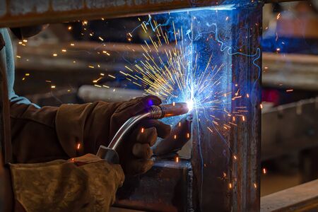 Semi-automatic welding with sparks and smoke closeupの写真素材