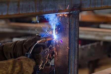 Semi-automatic welding with sparks and smoke closeupの写真素材