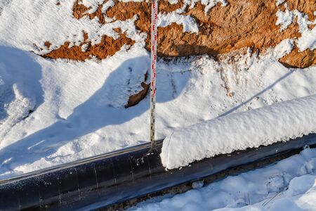 Measurement of geometrical quantities of the main pipeline laid in trench in winterの写真素材