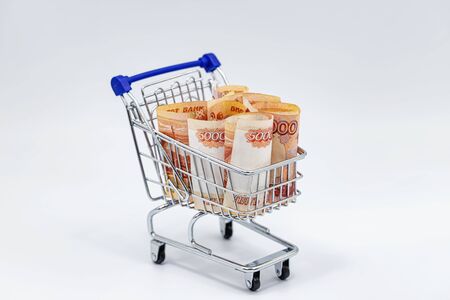 In a toy grocery cart rolled banknotes in 5000 rublesの写真素材