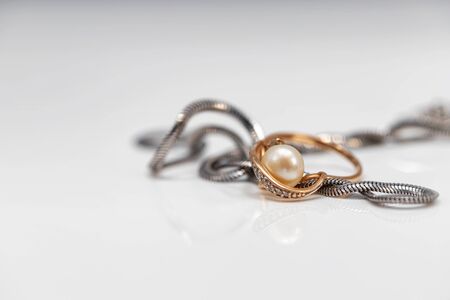 Silver chain with elegant design and gold pearl ringの写真素材