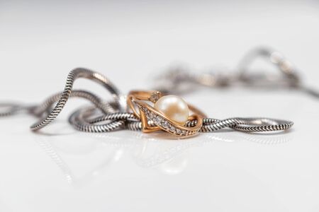 Silver chain with elegant design and gold pearl ring