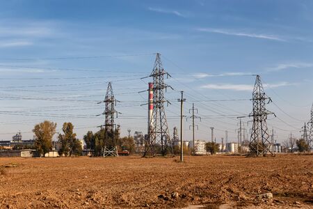 A high voltage power line runs near a chemical plantの写真素材