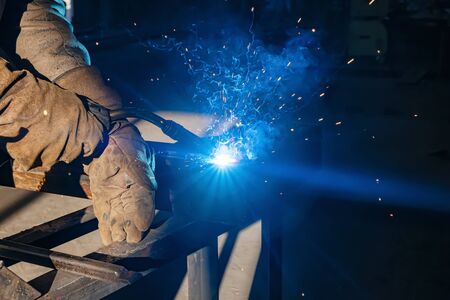 Semi-automatic welding with sparks and smoke closeupの写真素材
