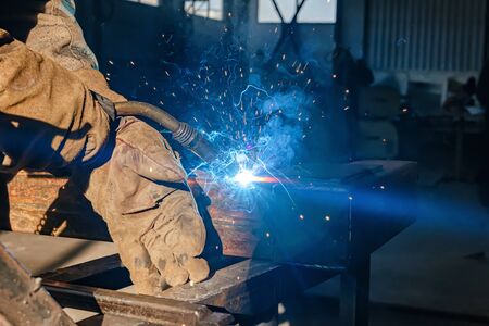 Semi-automatic welding with sparks and smoke closeupの写真素材