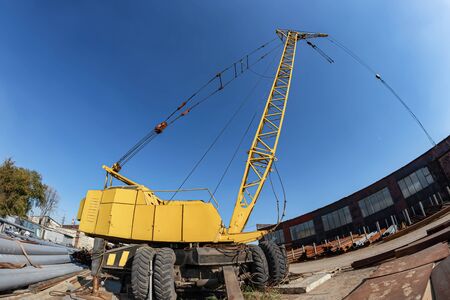 Wheeled truck crane for loading heavy metal in the warehouse of the production base of metal structuresの写真素材