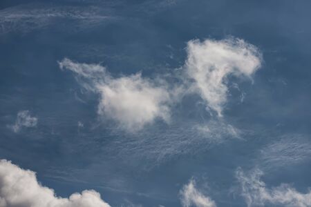 Light fluffy white clouds on a blue sky on a Sunny dayの写真素材