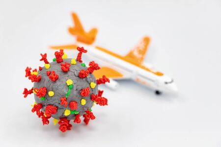 3D model of the SARS-CoV-2 virus drawn with a 3D pen and a toy model of an airplaneの写真素材