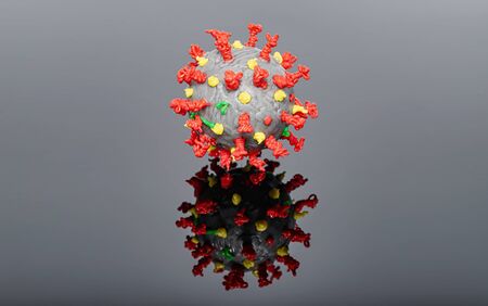 Model of the SARS-CoV-2 virus that causes COVID-19 coronavirus infection, made with a 3D pen on a black reflective surfaceの写真素材