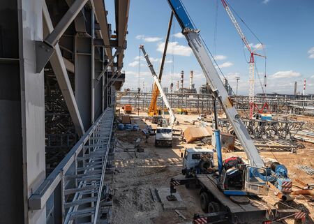 Ready-to-work truck crane on the construction site of an oil refineryの写真素材
