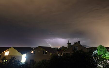A flash of lightning against the evening sky and mountain rangesの写真素材