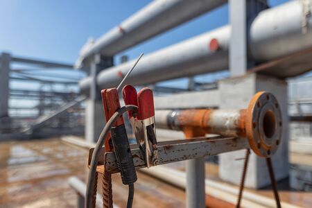welder's  workplace in an open area of a chemical plant under construction