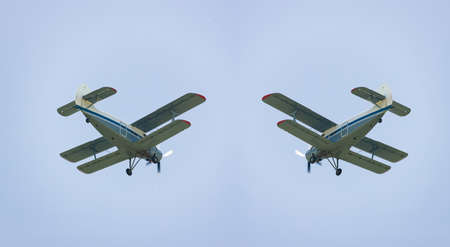 Light-engine propeller biplane aircraft AN-2 flying in the sky. View from the ground のeditorial素材