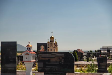 Black marble tombstone with an image of an Orthodox icon. Cemetery of the mountainous region of the Caucasusの写真素材