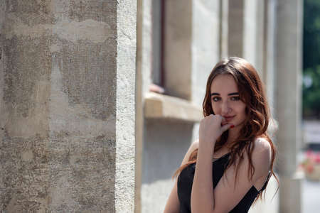 Charming red-haired teen girl in the Park posing for the camera