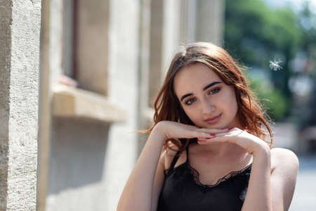 Charming red-haired teen girl in the Park posing for the camera