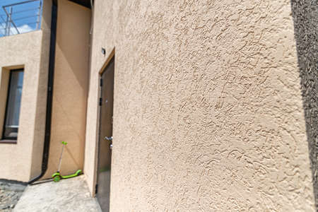 Pattern of decorative plaster "bark beetle" on the wall of the houseの写真素材