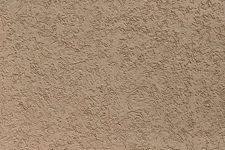 Pattern of decorative plaster "bark beetle" on the wall of the house. Beige colorの写真素材