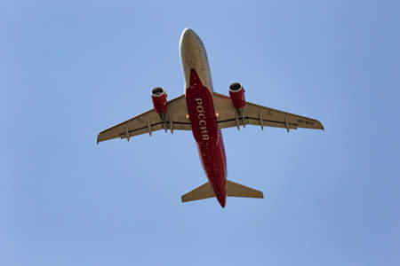 MINERALNYE VODY - SEPTEMBER 05: TAn Airbus A319-111 of RUSSIA airlines with the tail number VQ-BCO flies over the observer. View from the ground on the plane. September 05, 2020 in Mineralnye Vody, Russia.のeditorial素材