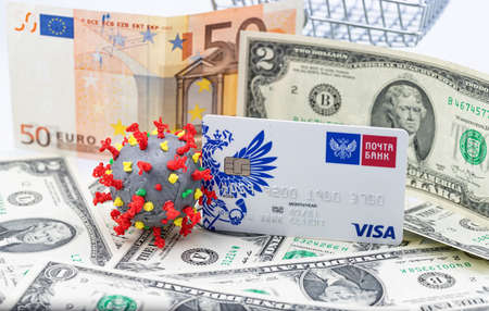ESSENTUKI - SEPTEMBER 20: A model of coronavirus in a shopping cart and a VISA Bank card. September 20, 2020 in Essentuki, Russia.のeditorial素材