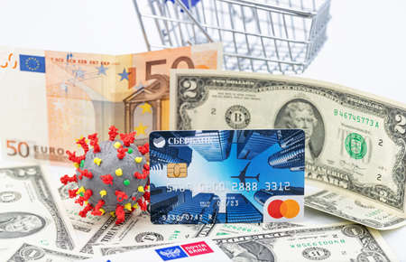ESSENTUKI - SEPTEMBER 20: A model of coronavirus in a shopping cart and a VISA Bank card. September 20, 2020 in Essentuki, Russia.のeditorial素材