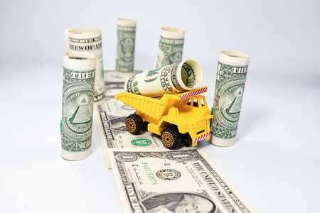 Toy construction equipment harvests wood and loads it on a truckの写真素材