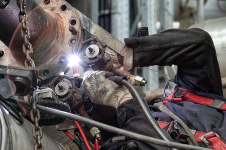 Argon arc welding in difficult conditions when repairing small diameter process fittings on an old transfer pipelineの写真素材