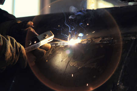 The process of electric arc welding of technological equipment made of carbon steel close-up