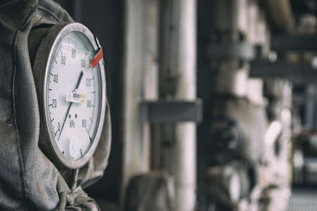 The pressure sensor is installed on the pipeline with thermal insulation. A red label is installed on the device body indicating the critical value of the readings.の写真素材