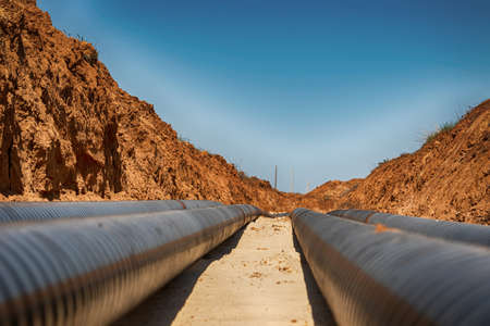 The lines of technological pipelines in special anti-corrosion insulation are laid on the bottom of the trenchの写真素材
