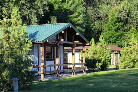 Wooden house on a country recreation center with a green lawn at the entranceの写真素材