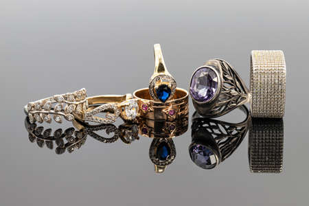 Gold and silver rings of different shapes and with different precious stonesの写真素材