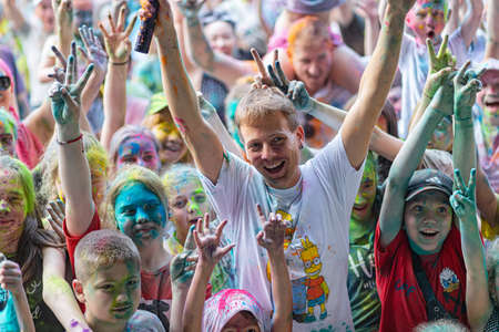 ESSENTUKI- JUNE 20: Happy participants of the open-air paint festival with painted faces and clothes. June 20, 2021 in Essentuki, Russia.のeditorial素材