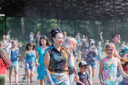 ESSENTUKI- JUNE 20: Happy participants of the open-air paint festival with painted faces and clothes. June 20, 2021 in Essentuki, Russia.のeditorial素材