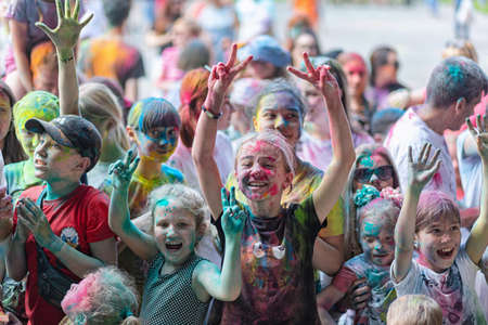 ESSENTUKI- JUNE 20: Happy participants of the open-air paint festival with painted faces and clothes. June 20, 2021 in Essentuki, Russia.のeditorial素材