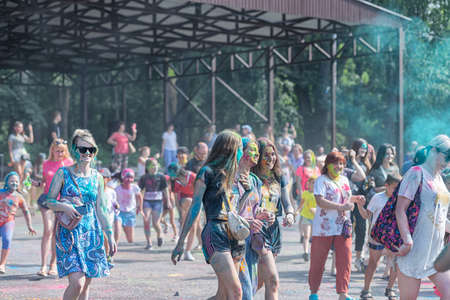 ESSENTUKI- JUNE 20: Happy participants of the open-air paint festival with painted faces and clothes. June 20, 2021 in Essentuki, Russia.のeditorial素材