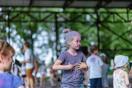 ESSENTUKI- JUNE 20: Happy participants of the open-air paint festival with painted faces and clothes. June 20, 2021 in Essentuki, Russia.のeditorial素材