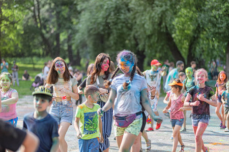 ESSENTUKI- JUNE 20: Happy participants of the open-air paint festival with painted faces and clothes. June 20, 2021 in Essentuki, Russia.のeditorial素材