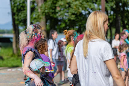 ESSENTUKI- JUNE 20: Happy participants of the open-air paint festival with painted faces and clothes. June 20, 2021 in Essentuki, Russia.のeditorial素材