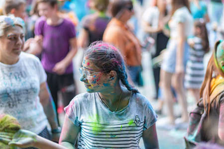 ESSENTUKI- JUNE 20: Happy participants of the open-air paint festival with painted faces and clothes. June 20, 2021 in Essentuki, Russia.のeditorial素材