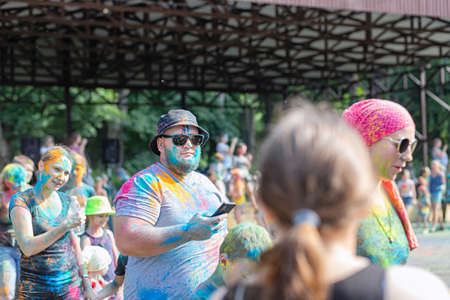 ESSENTUKI- JUNE 20: Happy participants of the open-air paint festival with painted faces and clothes. June 20, 2021 in Essentuki, Russia.のeditorial素材