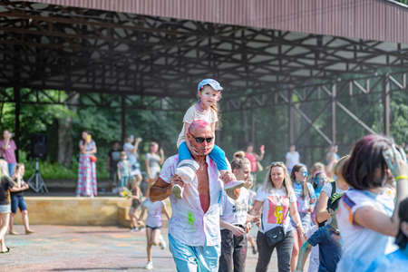 ESSENTUKI- JUNE 20: Happy participants of the open-air paint festival with painted faces and clothes. June 20, 2021 in Essentuki, Russia.のeditorial素材