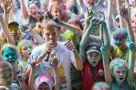 ESSENTUKI- JUNE 20: Happy participants of the open-air paint festival with painted faces and clothes. June 20, 2021 in Essentuki, Russia.のeditorial素材