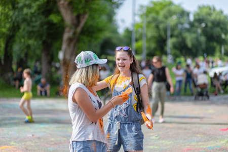 ESSENTUKI- JUNE 20: Happy participants of the open-air paint festival with painted faces and clothes. June 20, 2021 in Essentuki, Russia.のeditorial素材