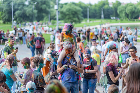 ESSENTUKI- JUNE 20: Happy participants of the open-air paint festival with painted faces and clothes. June 20, 2021 in Essentuki, Russia.のeditorial素材